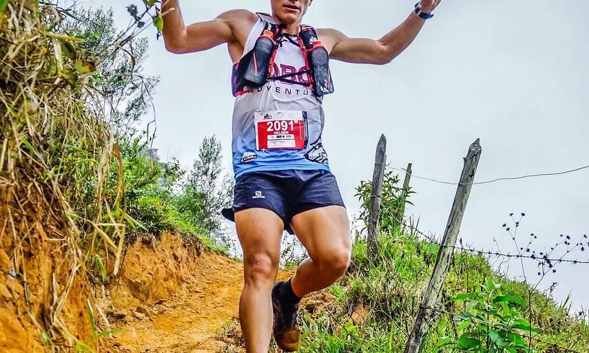 Trail runner cheering on a mountain path