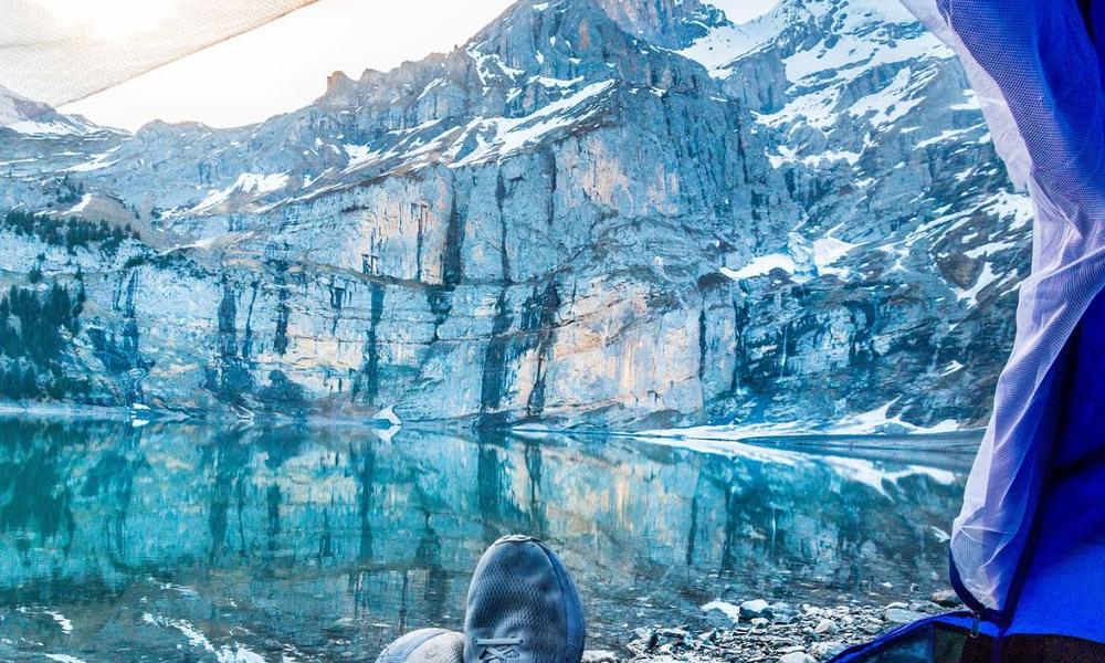 View from a hammock over a mountain lake in morning light