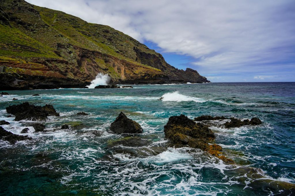 Stunning coastal view with waves crashing on rocky shores in La Palma, Spain.