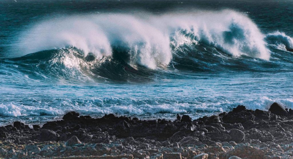 Captivating image of ocean waves crashing against the rocky shore of Lanzarote, Spain.