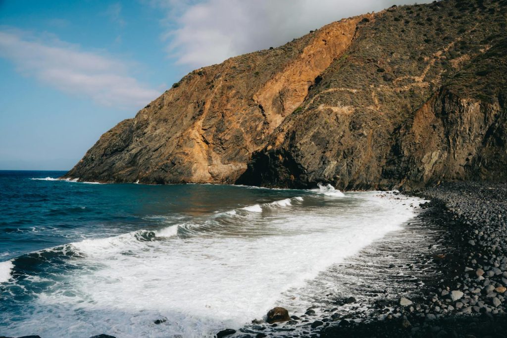 Explore the rugged coastal cliffs and serene beach of Vallehermoso on the Canary Islands.