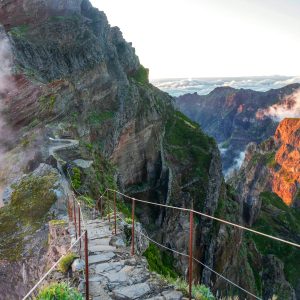 Experience stunning mountain views and scenic trails in Madeira, Portugal during sunrise.