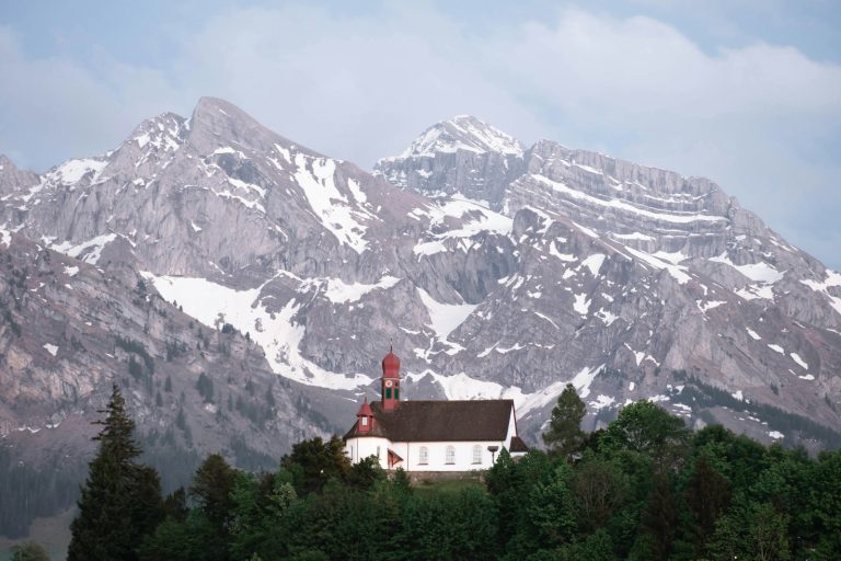 a house in front of a mountain